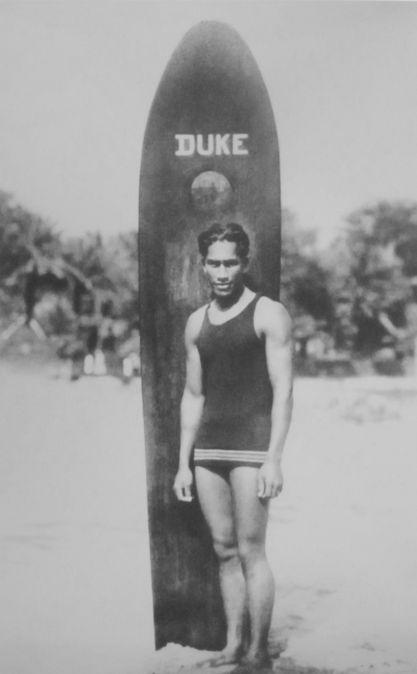 Duke Paoa Kahanamoku with his surfboard San Diego
